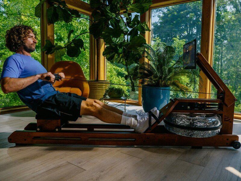 A person using egratta rower at home